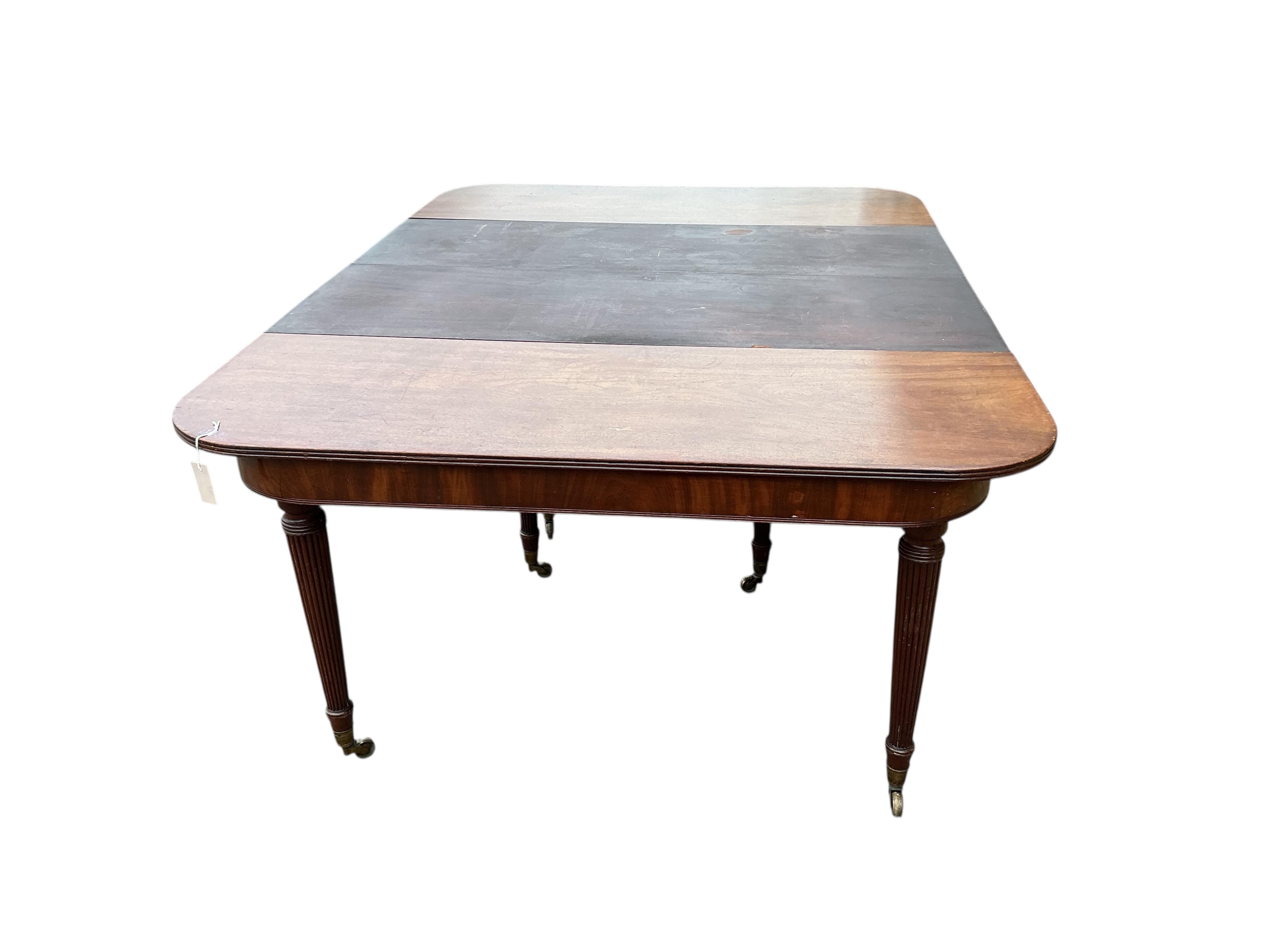 A Regency mahogany extending dining table, width 180cm extended, two spare leaves, depth 140cm, height 74cm